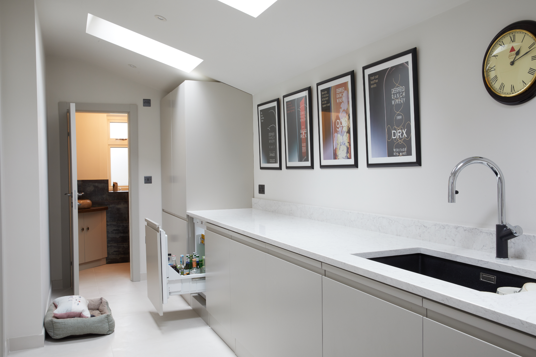 Bespoke utility with scallopped handles and quartz tops with drinks fridge and tall storage