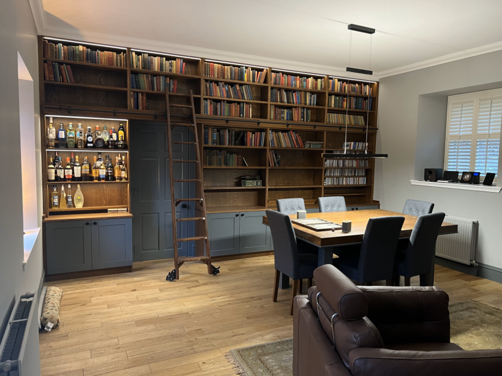 Library in a medium oak with painted doors in Dulux Heritage paint with library ladder and a matching table